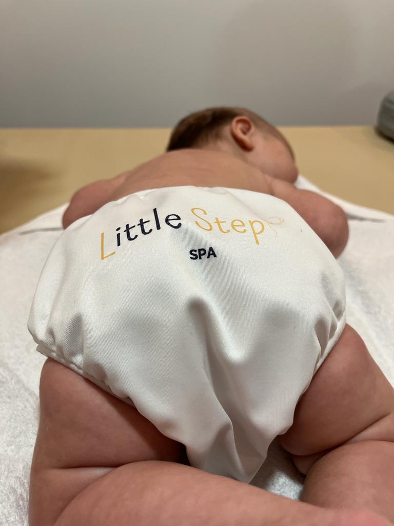 Bebé deitado no SPA do Little Steps pronto para receber uma massagem.